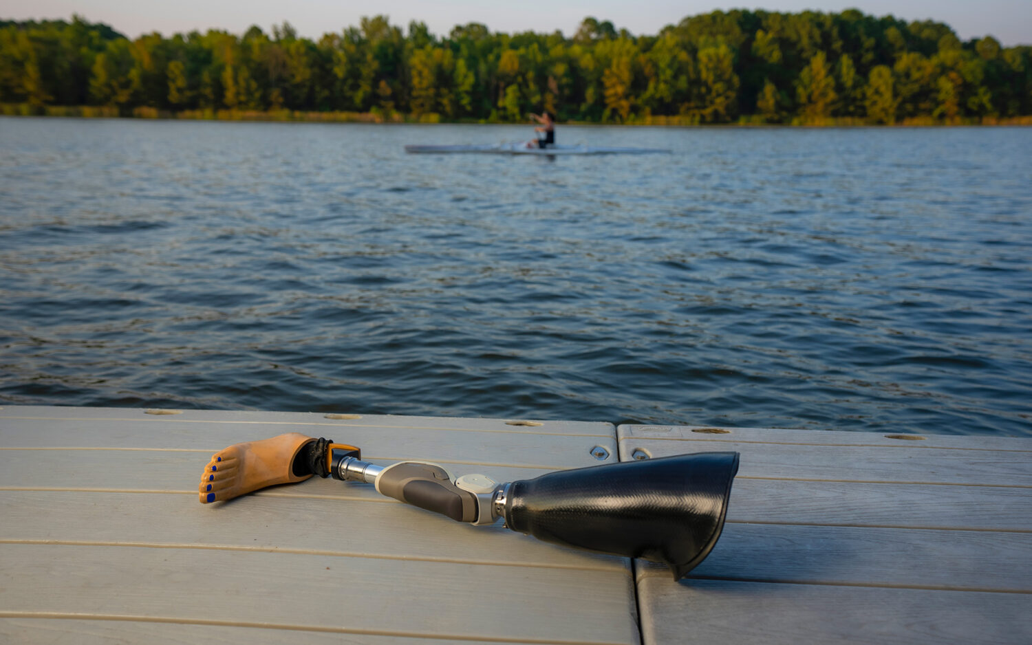 JIllian's prosthetic leg in foreground while she canoes in background.