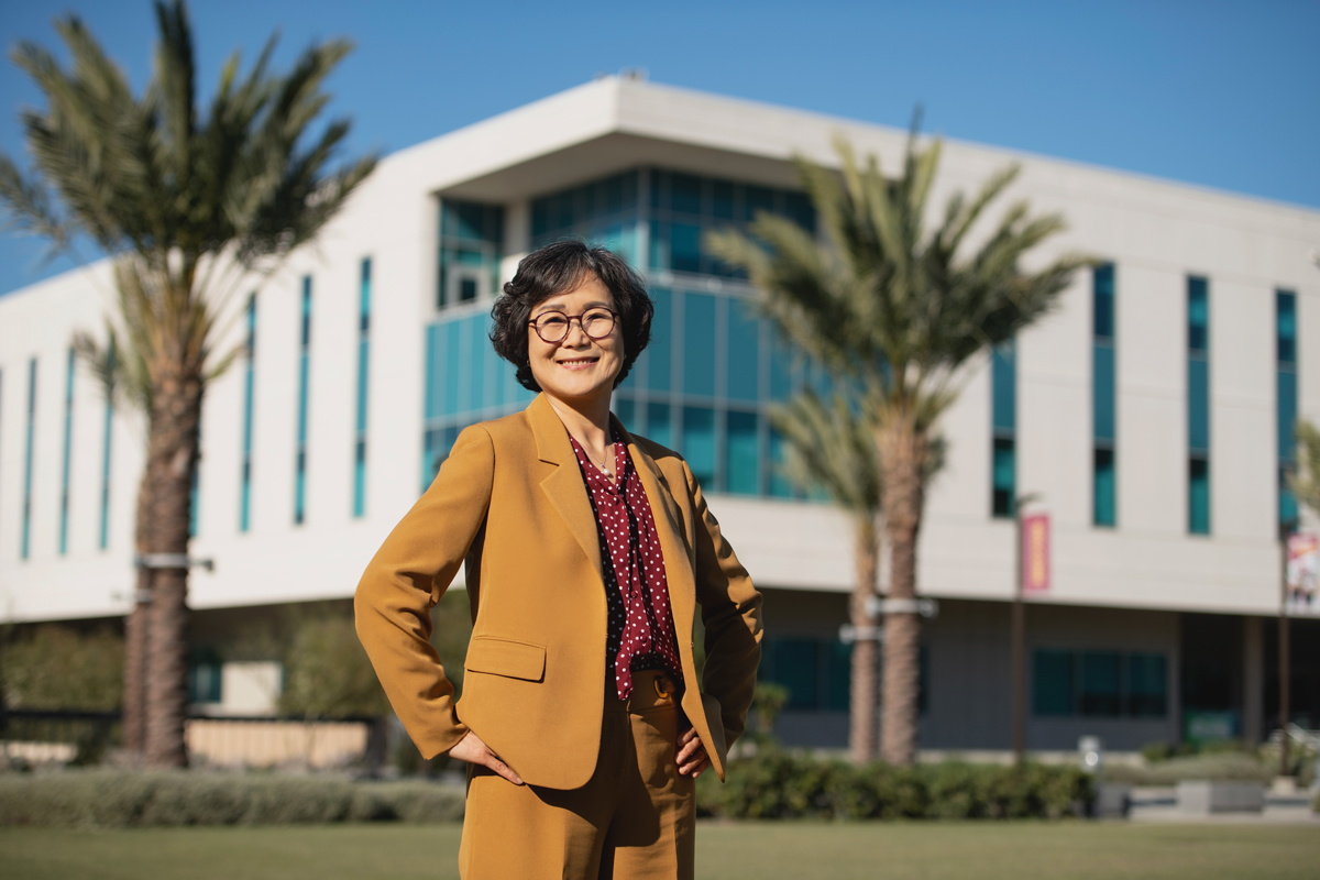 Dean Kim standing proudly in front of Welch Hall.