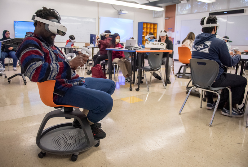 Crogman teaching class using VR headsets.
