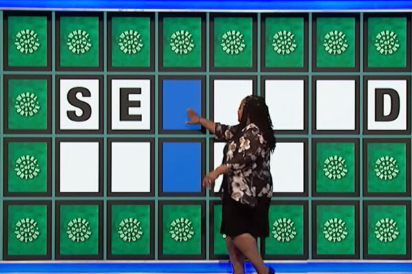 Bridgette changing letters on Wheel of Fortune game board.