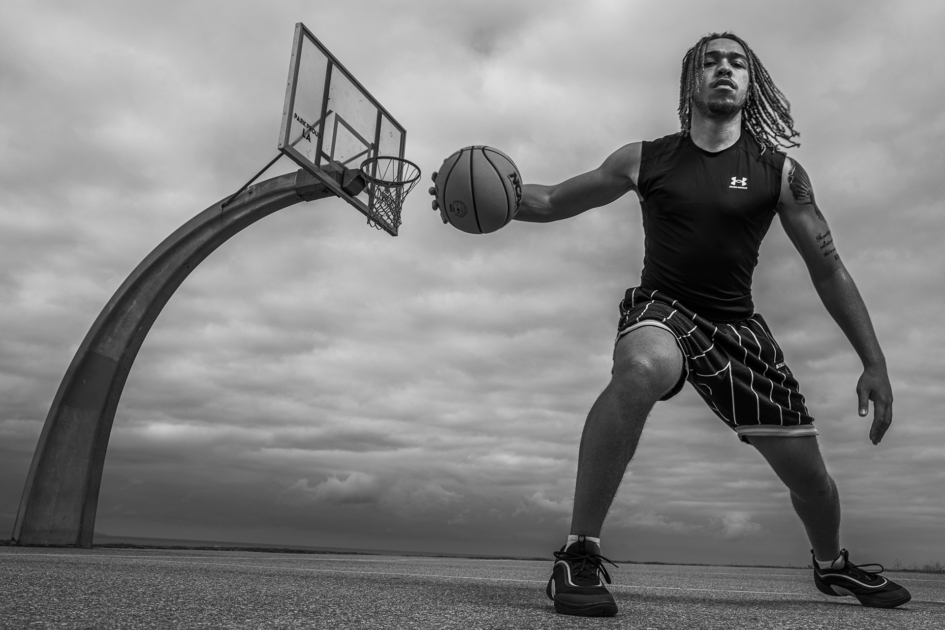 Jeremy Dent-Smith dribbling basketball with hoop in background.
