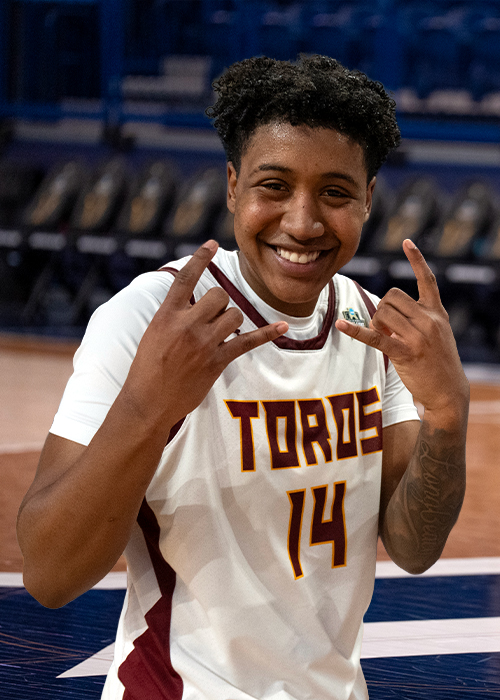 Nala Williams in uniform signing the Toro hand sign