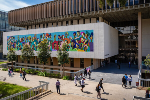 Mural depicting abstract faces blooming from stems