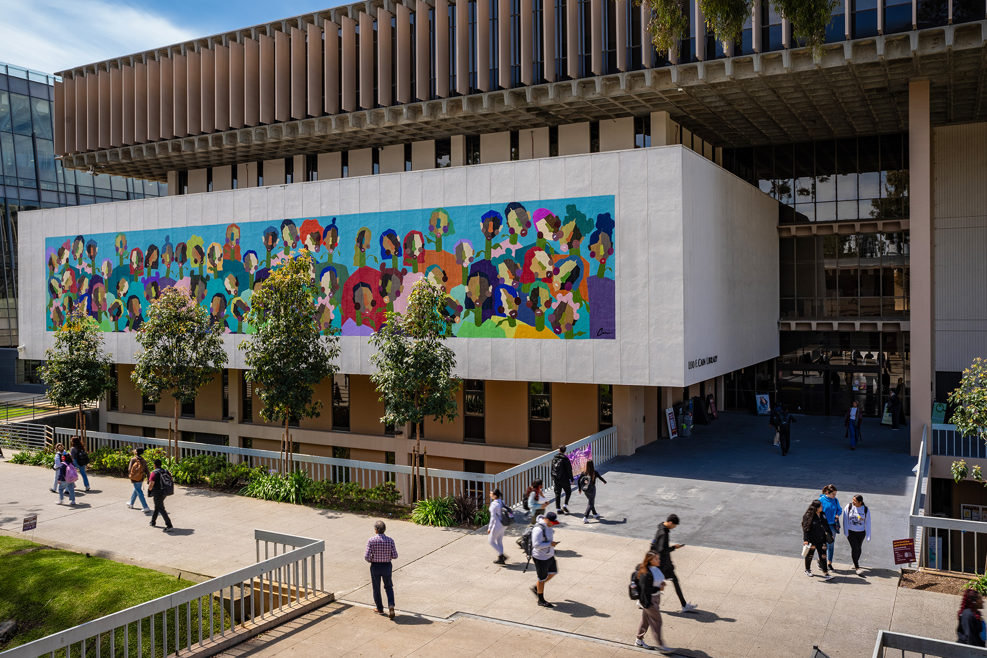 Mural depicting abstract faces blooming from stems